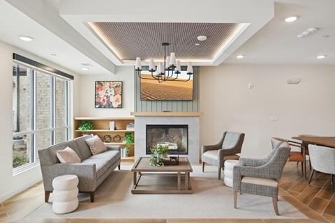 A living room with a fireplace and a painting on the wall.