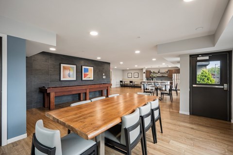 A modern dining room with a wooden table and chairs.