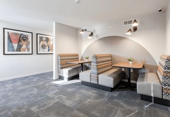 a seating area with two tables and two chairs