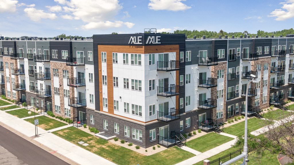 an aerial view of an apartment building with balconies and a sign that reads me