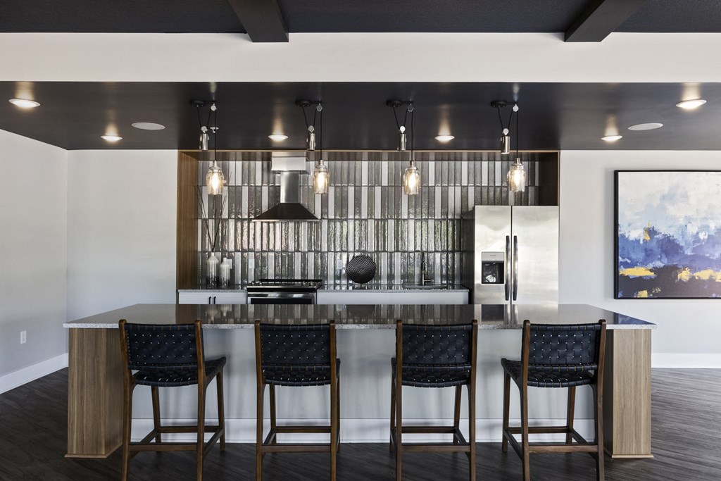a kitchen with a marble counter top and bar stools