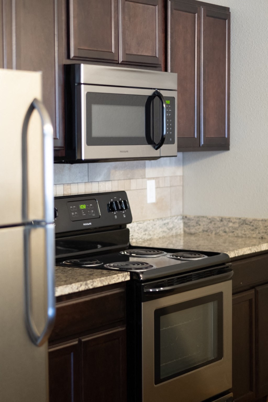 a kitchen with a stove microwave and refrigerator