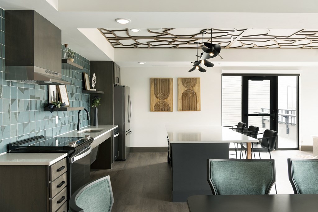 a kitchen and dining area with a black counter top and a black