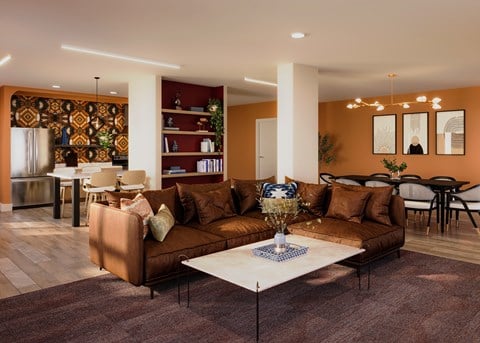 A living room with a brown sofa and a coffee table.
