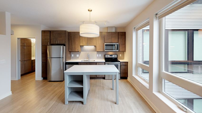 a kitchen with a large window and a table in the middle of the room