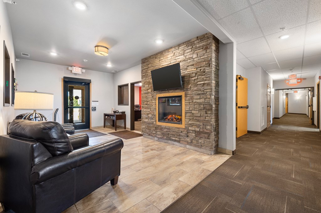 a living room with a fireplace and a television