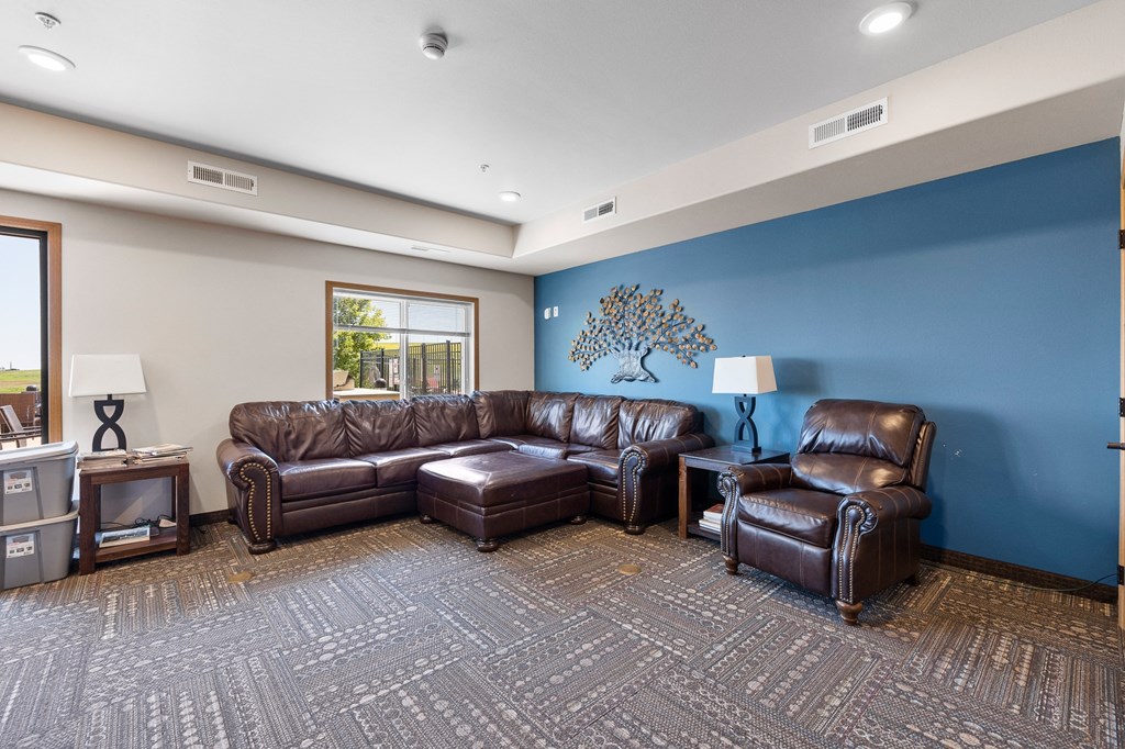 a large living room with leather couches and chairs