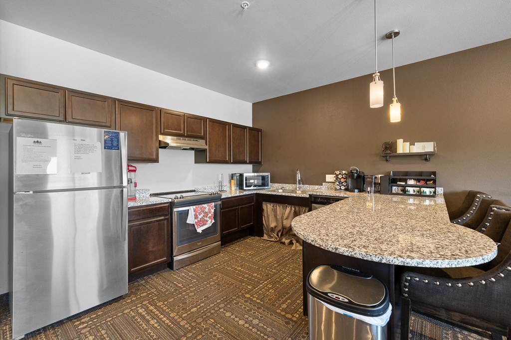 a kitchen with a granite counter top and stainless steel appliances