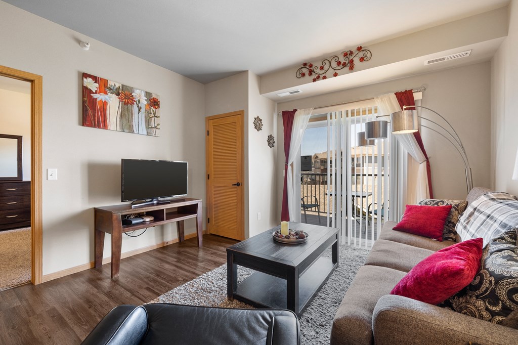 a living room with a couch a coffee table and a tv