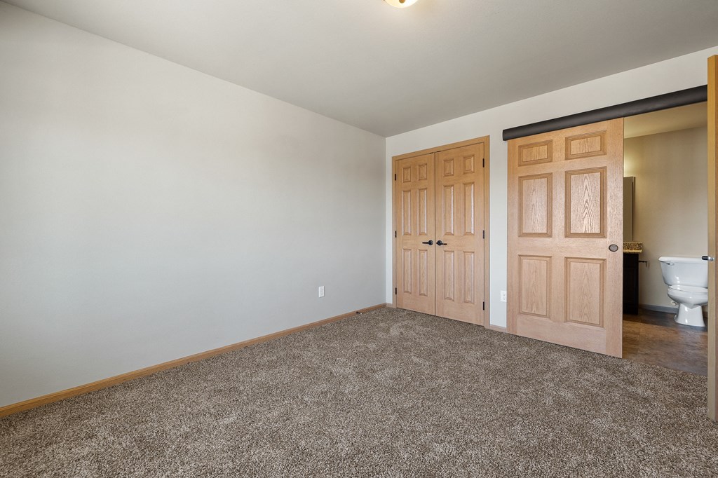 a bedroom with a toilet and a door