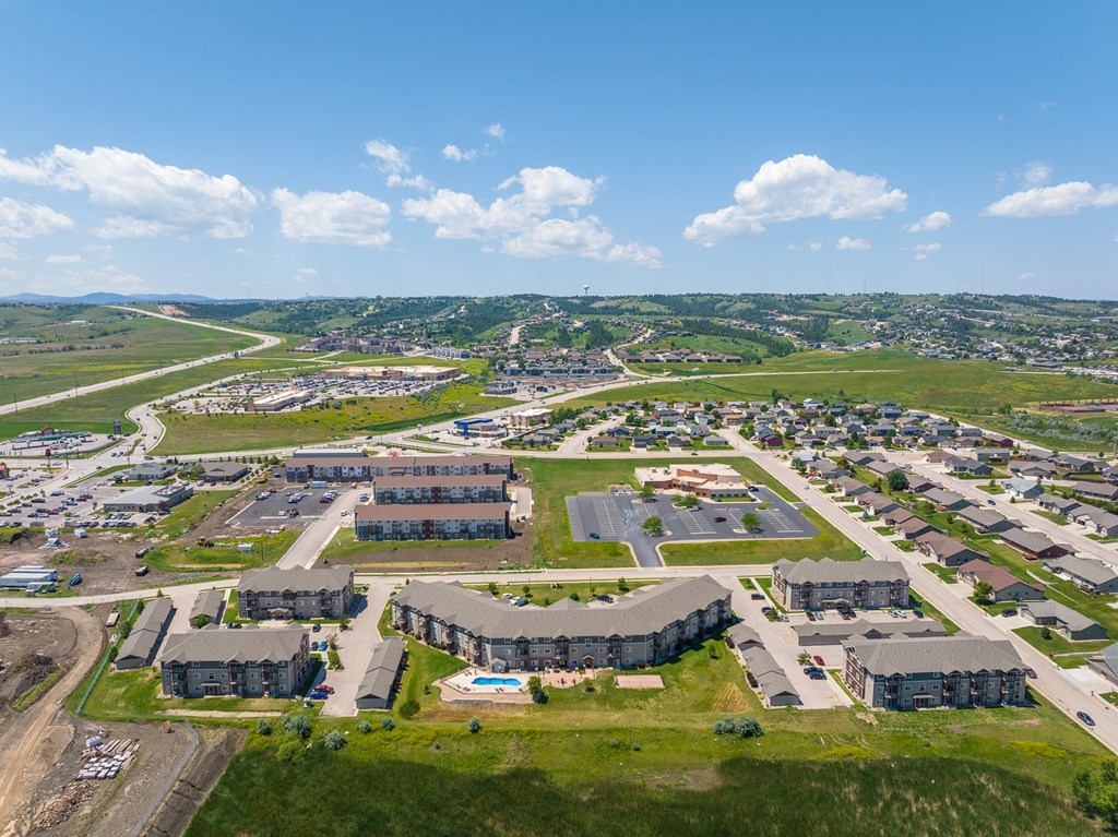 an aerial view of a city with a blue sky in the background