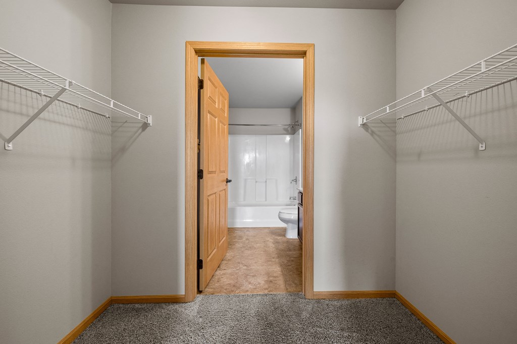 a walk in closet in a bedroom
