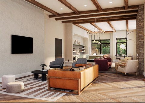 A living room with a wooden floor and a large flat screen TV mounted on the wall.