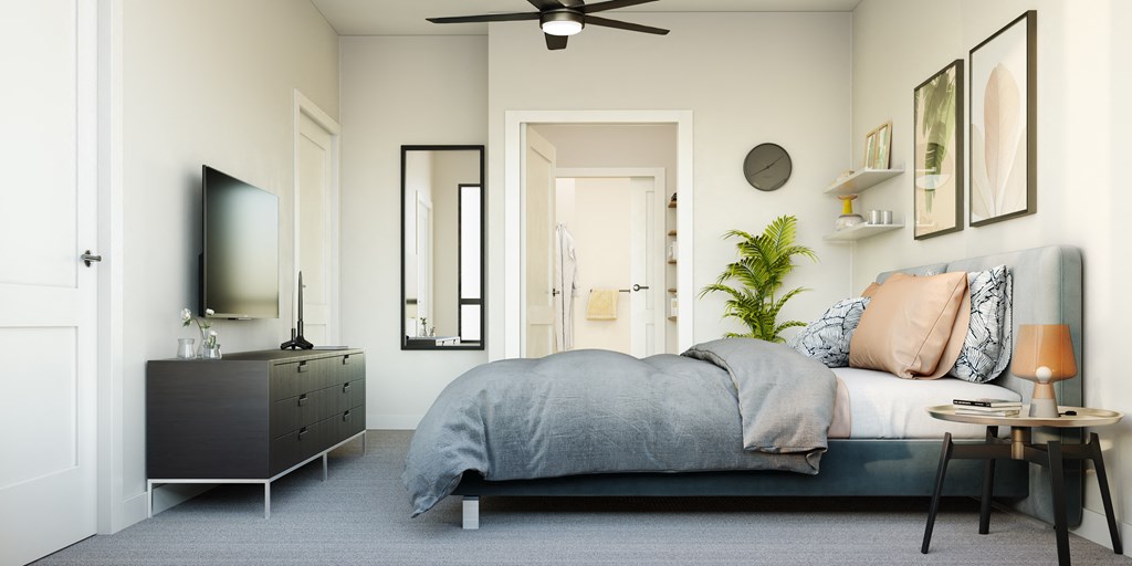 a bedroom with a bed and a dresser and a tv