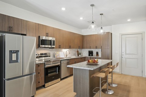 A modern kitchen with wooden cabinets and stainless steel appliances.