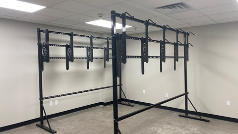 A gym with a squat rack and a wall mounted pull up bar.