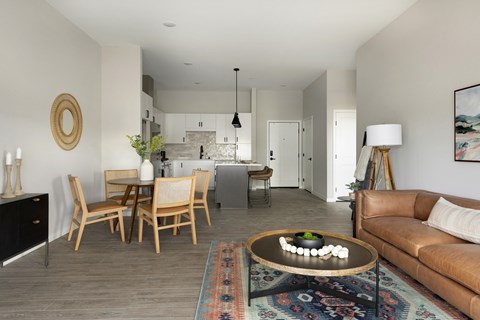 a living room and dining room with a couch and a table