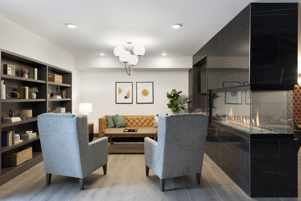 a living room with a couch and chairs and a fireplace