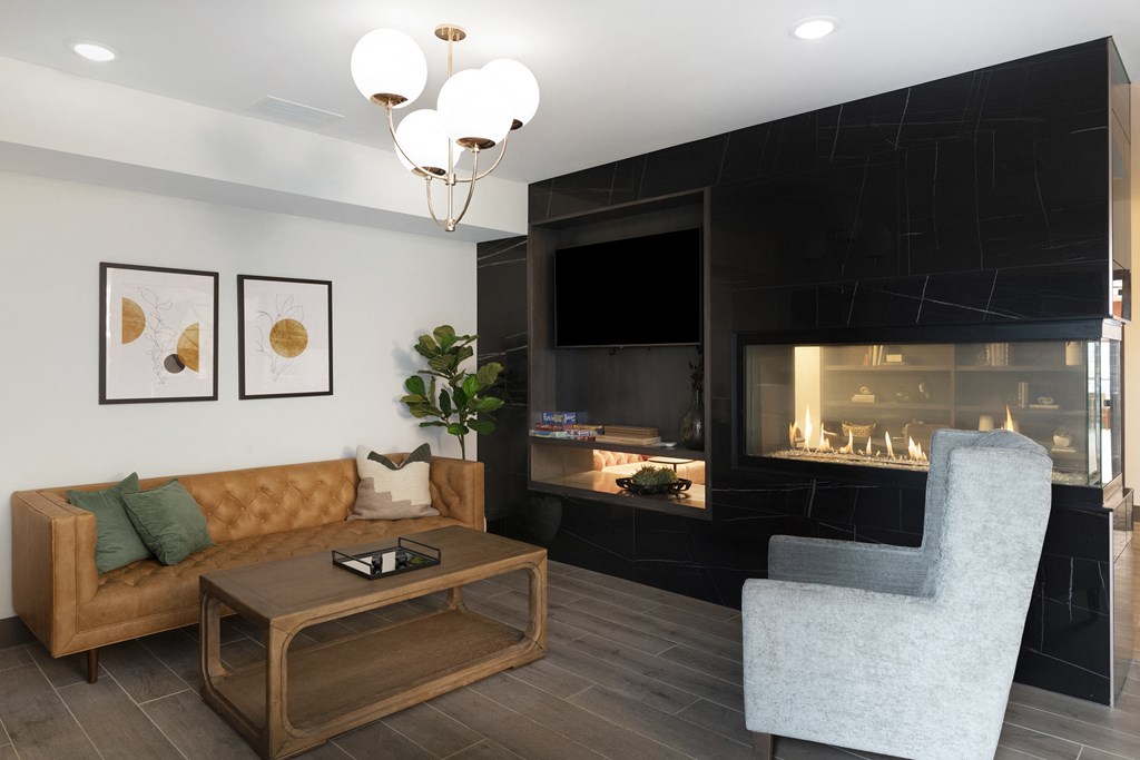 a living room with a couch and a coffee table and a fireplace