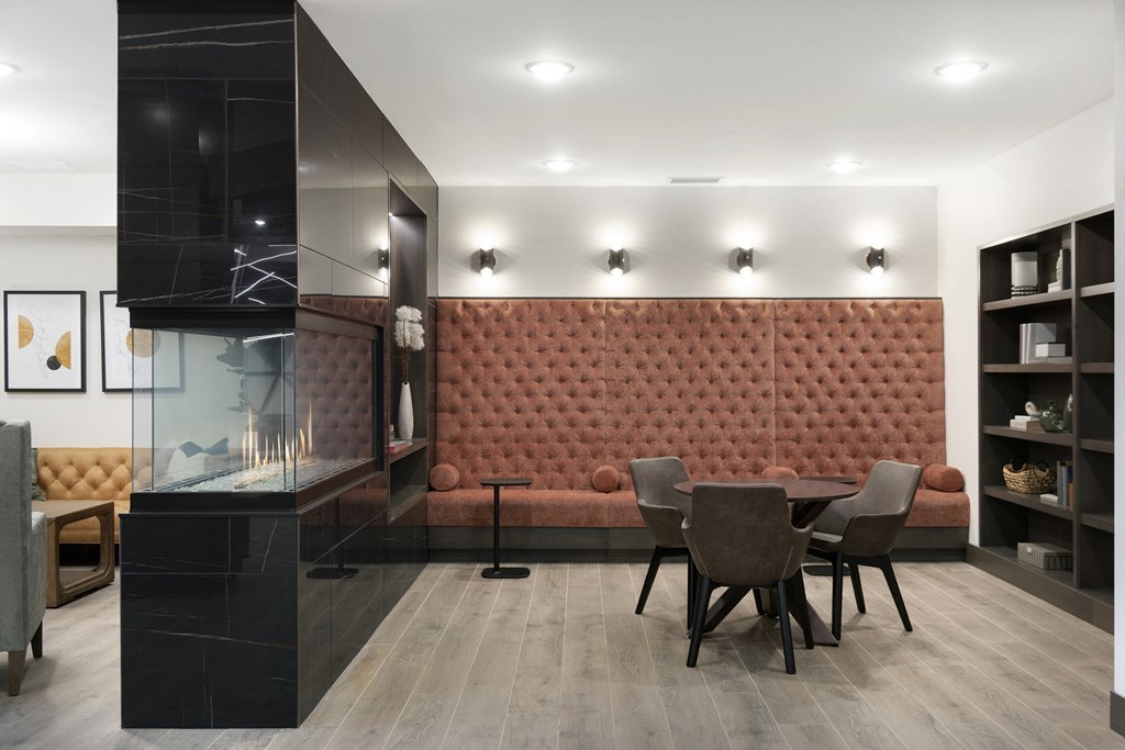 a dining room with a table and chairs and a large red bench