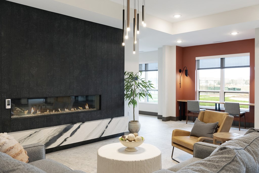 a living room with a couch and a coffee table and a fireplace