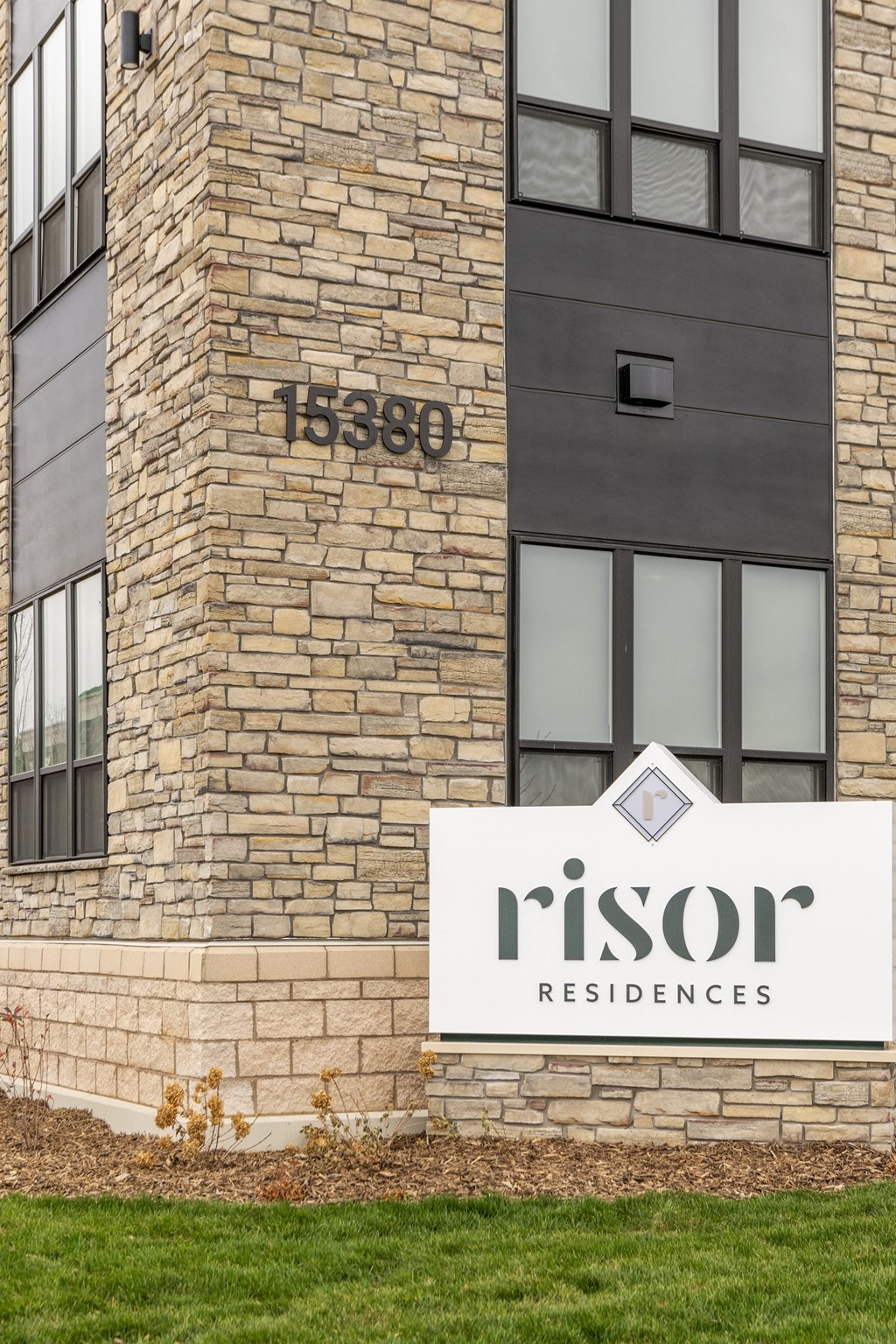 a rendering of the nisson residences sign in front of a brick building