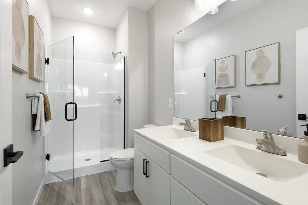 a bathroom with a sink and a shower and a toilet