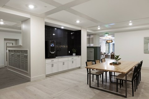A modern kitchen with a dining table and chairs.