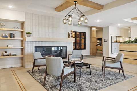 A modern living room with a fireplace and a chandelier.