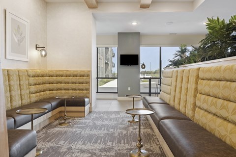 A modern living room with a large window and a flat screen TV.