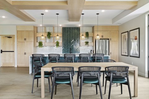 A modern dining room with a table set for six.