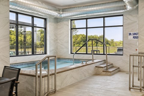 A sign in a room with a pool that says "SPA CAPACITY 7 PERSON".