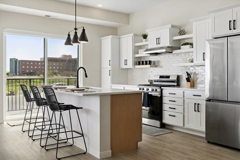 A modern kitchen with a white brick backsplash and stainless steel appliances.