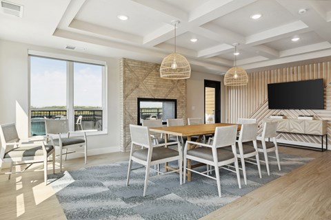 A modern dining room with a wooden table and chairs.
