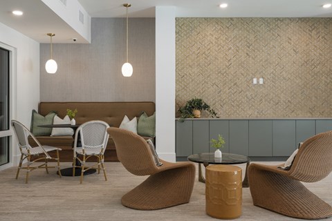 A modern living room with a brown sofa and matching chairs.