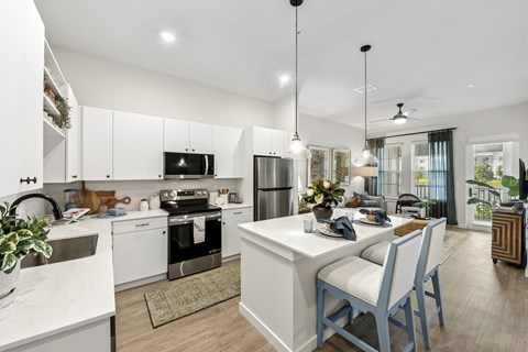 A modern kitchen with a dining table and chairs.