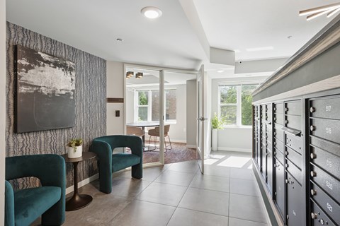 A modern living room with a green chair and a grey wall.