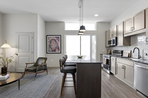 A modern kitchen with a dining table and chairs.