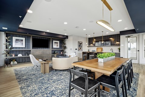 A modern kitchen with a dining table and chairs.