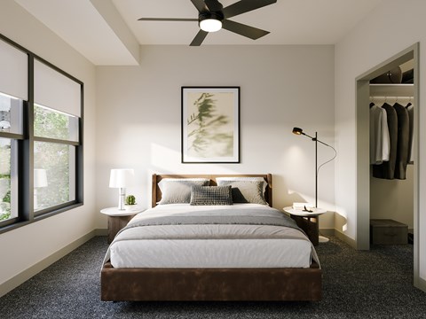 A bedroom with a large bed and a ceiling fan.