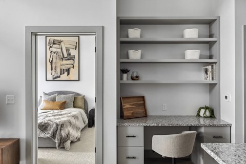 A bedroom with a bed and a mirror with a picture on it.