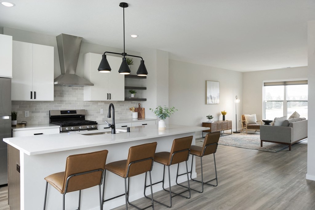 a kitchen and living room with a white counter top