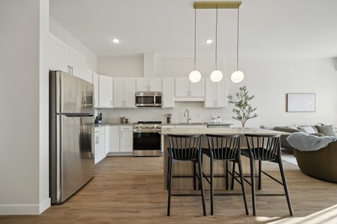 A modern kitchen with a dining table and chairs.