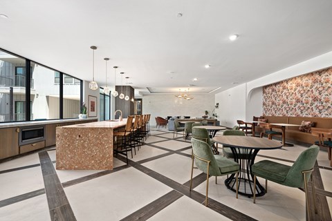 A modern kitchen with a dining table and chairs.