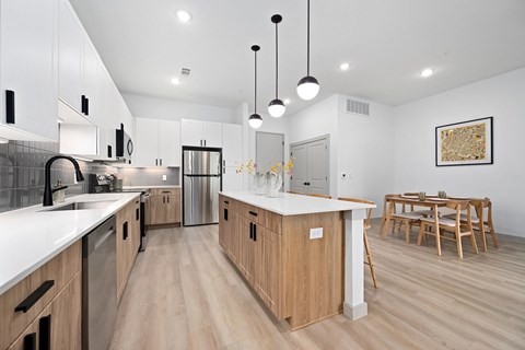 A modern kitchen with wooden cabinets and a white countertop.