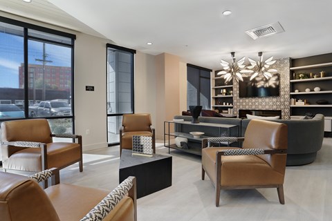 A modern living room with brown leather chairs and a black coffee table.