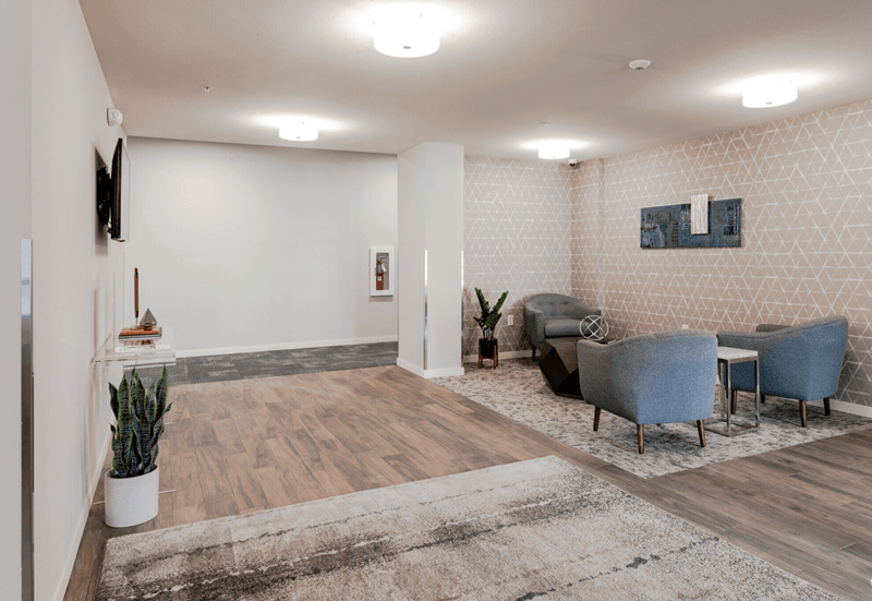 a resident clubhouse with couches chairs and a coffee table
