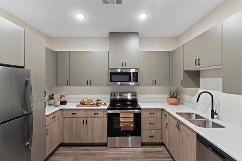 A modern kitchen with wooden cabinets and stainless steel appliances.