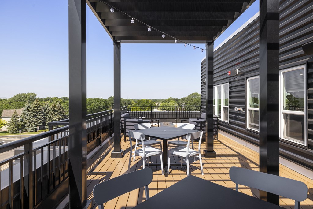 a patio with a table and chairs on a balcony