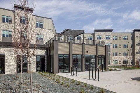 A modern building with a tree in front of it.